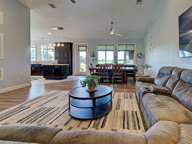 48 Lark Dr, Placida, FL 33946 - living room featuring a ceiling fan, light wood-style floors, and plenty of natural light