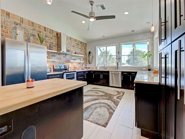 48 Lark Dr, Placida, FL 33946 - kitchen featuring stainless steel appliances, wall chimney exhaust hood, decorative backsplash, butcher block counters, and a ceiling fan