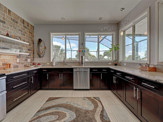 48 Lark Dr, Placida, FL 33946 - kitchen with dishwasher, plenty of natural light, light stone counters, and backsplash