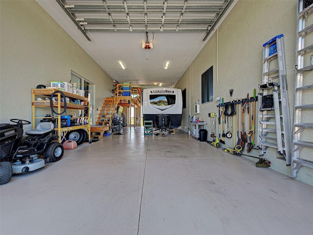 48 Lark Dr, Placida, FL 33946 - garage featuring a textured wall, a workshop area, and a garage door opener