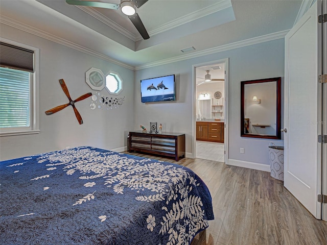 48 Lark Dr, Placida, FL 33946 - bedroom featuring wood finished floors, multiple windows, a raised ceiling, ornamental molding, and connected bathroom