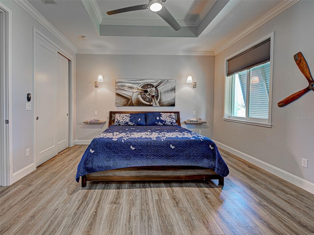 48 Lark Dr, Placida, FL 33946 - bedroom featuring a tray ceiling, wood finished floors, ceiling fan, and ornamental molding