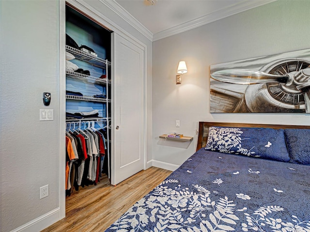 48 Lark Dr, Placida, FL 33946 - bedroom featuring wood finished floors, ornamental molding, and a closet