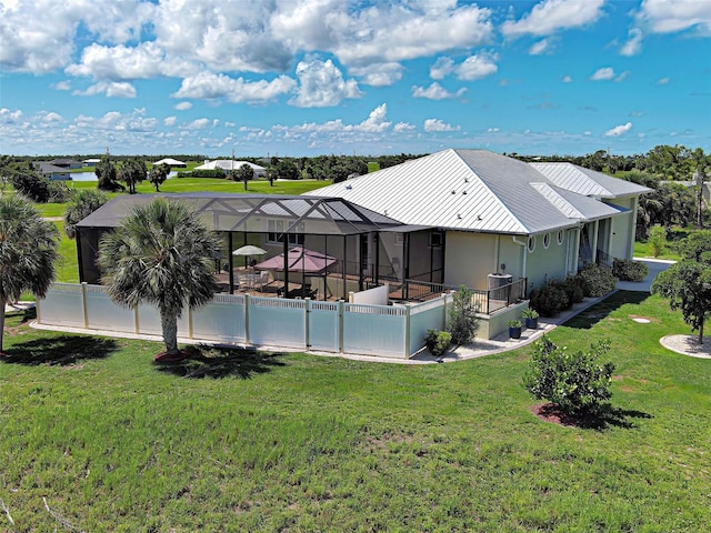 48 Lark Dr, Placida, FL 33946 - back of house featuring a lanai, a yard, stucco siding, and a metal roof