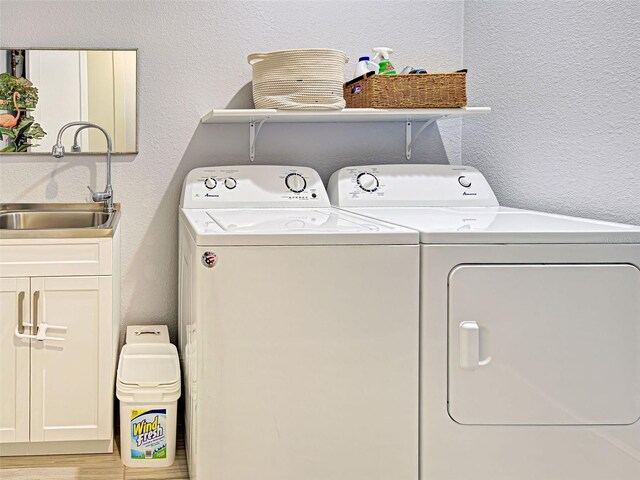 48 Lark Dr, Placida, FL 33946 - laundry room with independent washer and dryer, cabinet space, and a textured wall