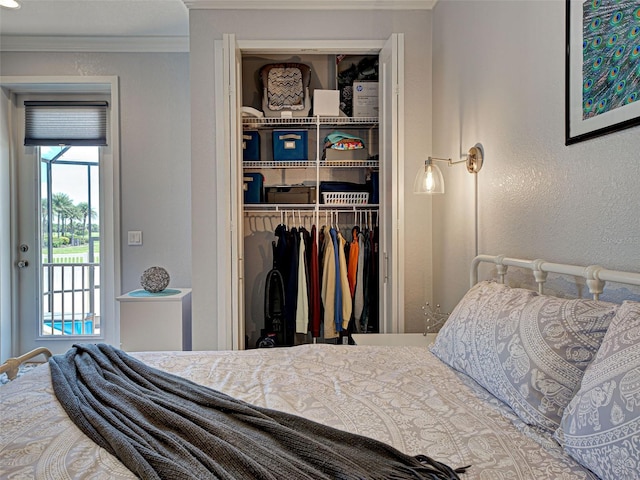 48 Lark Dr, Placida, FL 33946 - bedroom featuring a closet, ornamental molding, and a textured wall