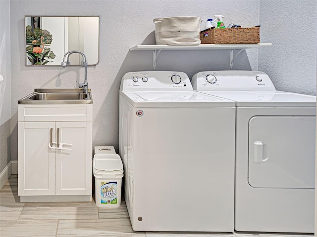 48 Lark Dr, Placida, FL 33946 - laundry room with independent washer and dryer, cabinet space, and a textured wall