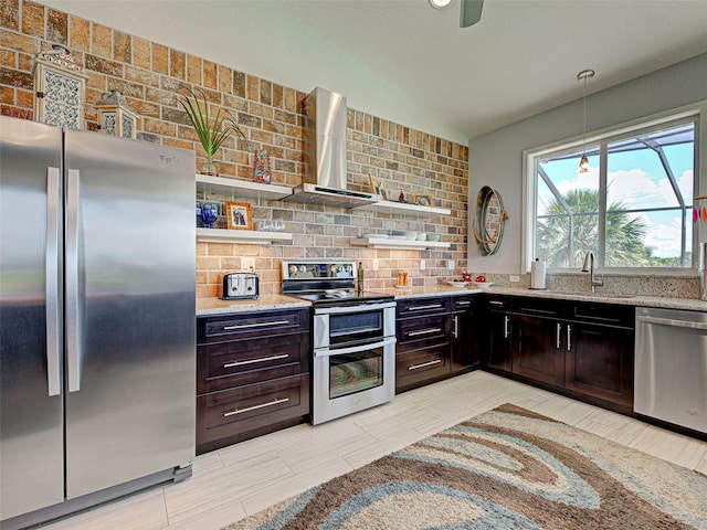 48 Lark Dr, Placida, FL 33946 - kitchen with stainless steel appliances, open shelves, wall chimney exhaust hood, lofted ceiling, and tasteful backsplash