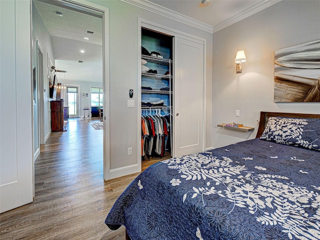 48 Lark Dr, Placida, FL 33946 - bedroom featuring wood finished floors, a closet, and ornamental molding