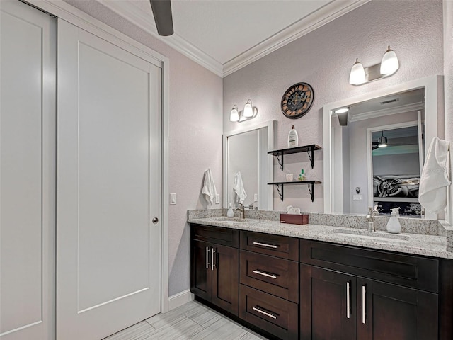 48 Lark Dr, Placida, FL 33946 - bathroom featuring crown molding, a textured wall, and double vanity