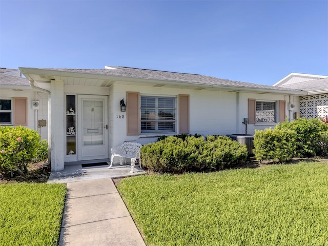 168 The Corso Unit 168, Venice, FL 34285 - view of front of home with a front yard and a shingled roof