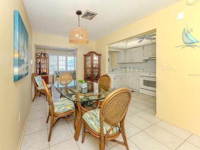 168 The Corso Unit 168, Venice, FL 34285 - dining area featuring ceiling fan and light tile patterned flooring