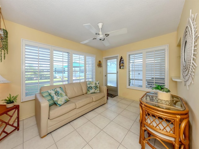 168 The Corso Unit 168, Venice, FL 34285 - living room with light tile patterned flooring, ceiling fan, and a textured ceiling
