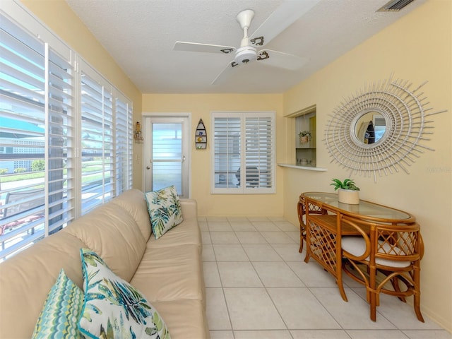 168 The Corso Unit 168, Venice, FL 34285 - tiled living area featuring ceiling fan and a textured ceiling