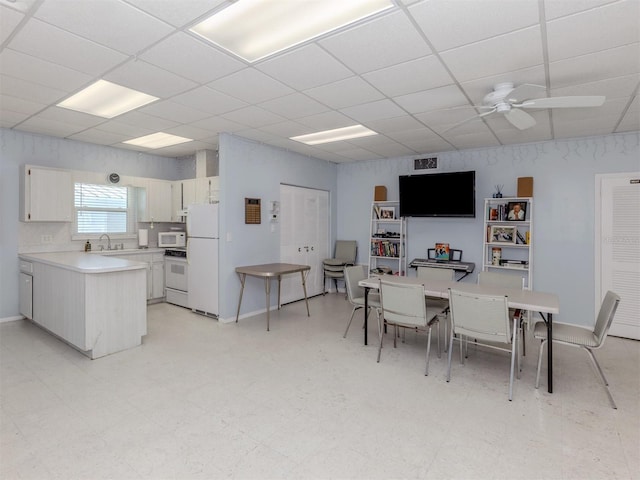 168 The Corso Unit 168, Venice, FL 34285 - dining space featuring a drop ceiling, ceiling fan, and light floors