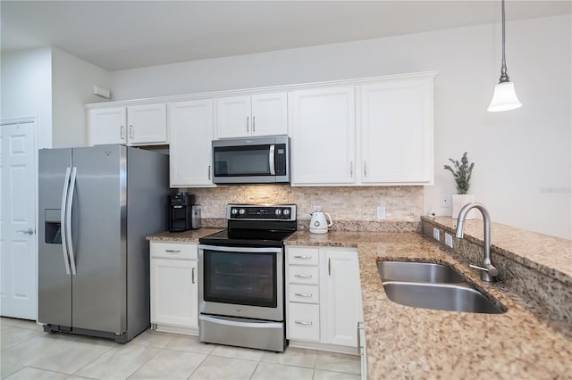 19269 Serafina St, Venice, FL 34293 - kitchen with stainless steel appliances, white cabinets, tasteful backsplash, light stone counters, and light tile patterned floors