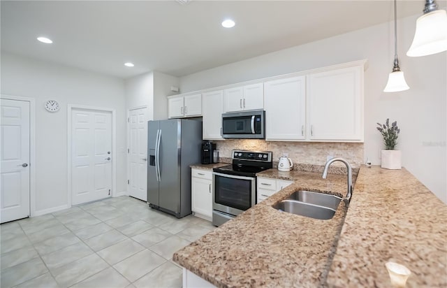19269 Serafina St, Venice, FL 34293 - kitchen with appliances with stainless steel finishes, white cabinetry, decorative backsplash, light stone counters, and recessed lighting