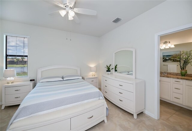 19269 Serafina St, Venice, FL 34293 - bedroom with light tile patterned flooring, ensuite bath, and ceiling fan