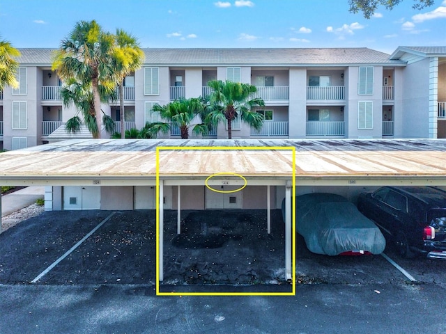 437 Cerromar Ln Unit 424, Venice, FL 34293 - view of building exterior featuring covered parking