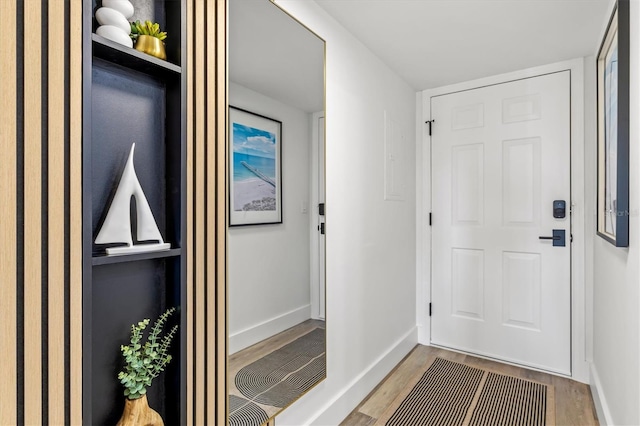437 Cerromar Ln Unit 424, Venice, FL 34293 - doorway with wood finished floors and baseboards
