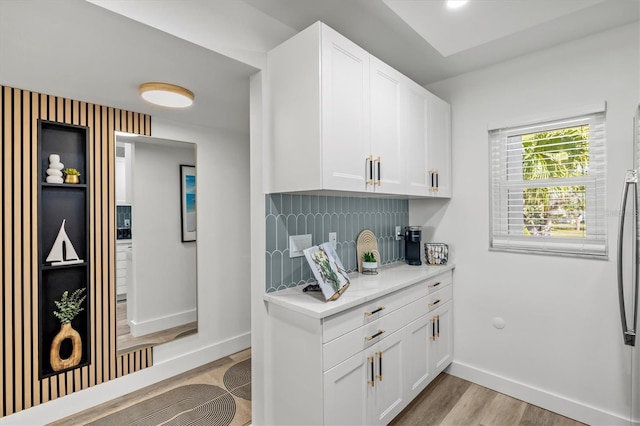 437 Cerromar Ln Unit 424, Venice, FL 34293 - kitchen with light wood-type flooring, light countertops, and white cabinets