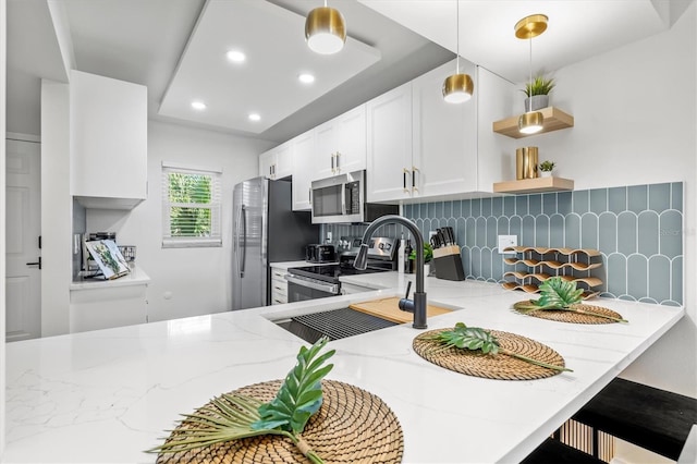 437 Cerromar Ln Unit 424, Venice, FL 34293 - kitchen featuring stainless steel appliances, tasteful backsplash, light stone counters, white cabinetry, and recessed lighting