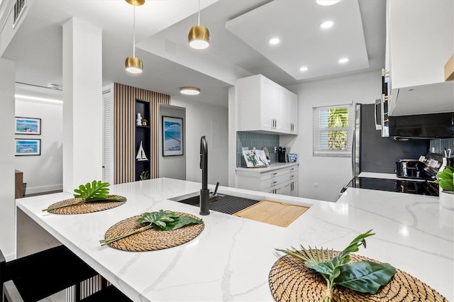 437 Cerromar Ln Unit 424, Venice, FL 34293 - kitchen featuring light stone countertops, pendant lighting, white cabinetry, recessed lighting, and range