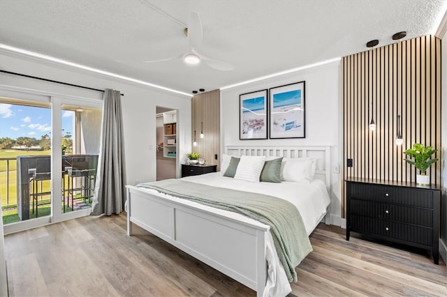 437 Cerromar Ln Unit 424, Venice, FL 34293 - bedroom with access to outside, a textured ceiling, light wood-style flooring, and a ceiling fan