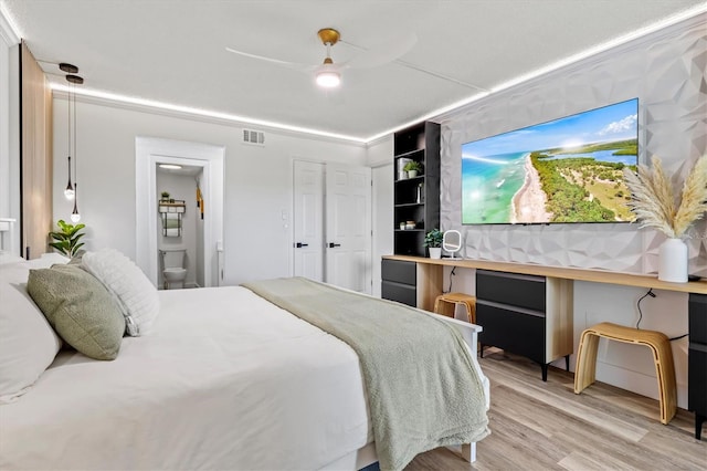 437 Cerromar Ln Unit 424, Venice, FL 34293 - bedroom featuring light wood-style flooring, ensuite bathroom, and a ceiling fan