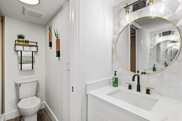 437 Cerromar Ln Unit 424, Venice, FL 34293 - bathroom with vanity, decorative backsplash, and wood finished floors
