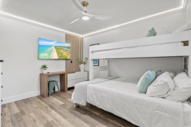 437 Cerromar Ln Unit 424, Venice, FL 34293 - bedroom with wood finished floors, a ceiling fan, and a textured ceiling