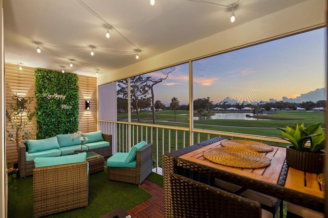 437 Cerromar Ln Unit 424, Venice, FL 34293 - sunroom featuring track lighting, a water view, and view of golf course
