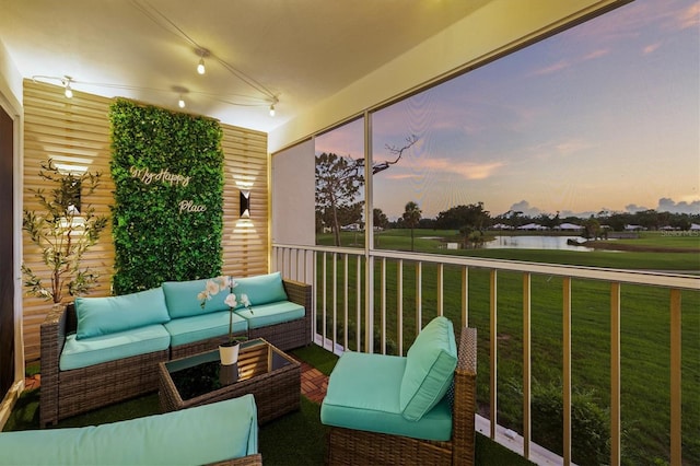 437 Cerromar Ln Unit 424, Venice, FL 34293 - balcony at dusk featuring a water view and an outdoor living space
