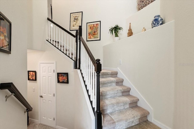 935 Tidewater Shrs Unit 721, Bradenton, FL 34208 - staircase with tile patterned floors and a towering ceiling