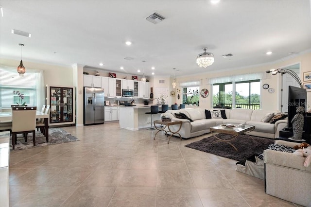 935 Tidewater Shrs Unit 721, Bradenton, FL 34208 - living room with crown molding, healthy amount of natural light, recessed lighting, a chandelier, and light tile patterned flooring