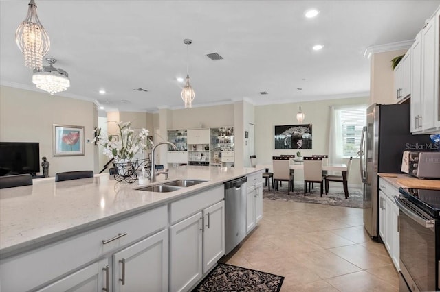 935 Tidewater Shrs Unit 721, Bradenton, FL 34208 - kitchen with stainless steel dishwasher, black range with electric cooktop, ornamental molding, white cabinets, and pendant lighting