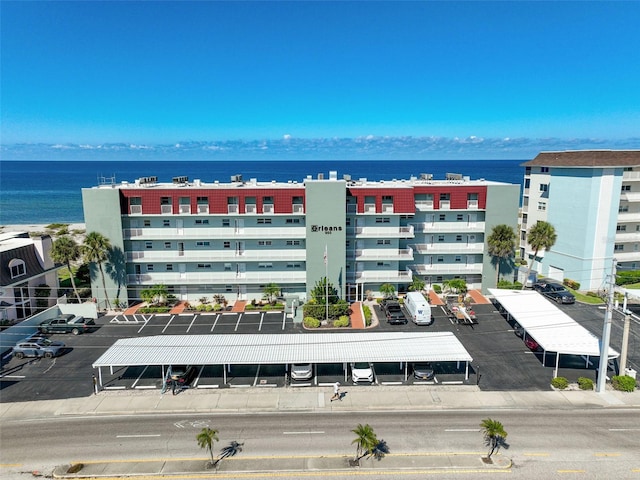 950 Tarpon Center Dr Unit 305, Venice, FL 34285 - view of building exterior featuring uncovered parking and a water view