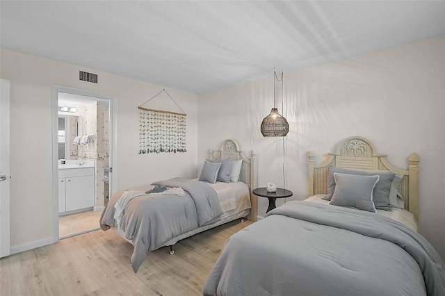 950 Tarpon Center Dr Unit 305, Venice, FL 34285 - bedroom with light wood-style floors and connected bathroom