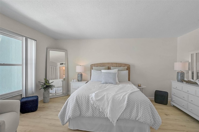 950 Tarpon Center Dr Unit 305, Venice, FL 34285 - bedroom with light wood finished floors and a textured ceiling