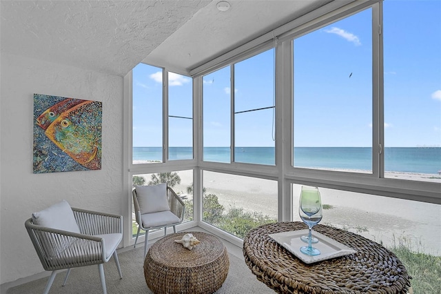 950 Tarpon Center Dr Unit 305, Venice, FL 34285 - sunroom with a textured wall, a water view, plenty of natural light, carpet floors, and a textured ceiling