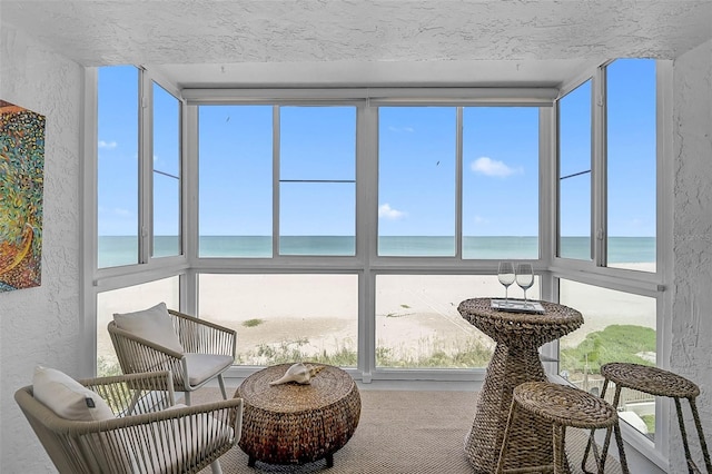 950 Tarpon Center Dr Unit 305, Venice, FL 34285 - sunroom with a textured wall, a water view, and carpet floors