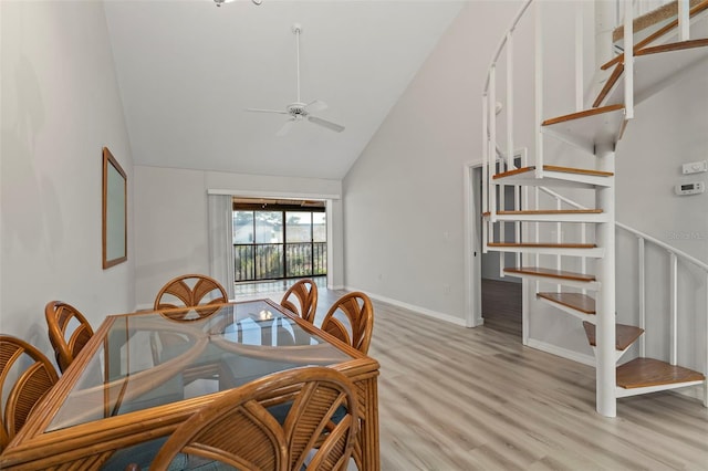 6800 Placida Rd Unit 280, Englewood, FL 34224 - dining space featuring high vaulted ceiling, light wood-type flooring, stairway, and a ceiling fan
