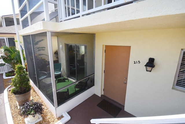 320 Base Ave E Unit 215, Venice, FL 34285 - property entrance with stucco siding and a balcony