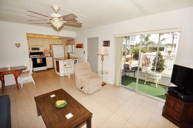 320 Base Ave E Unit 215, Venice, FL 34285 - living area featuring a ceiling fan and light tile patterned floors