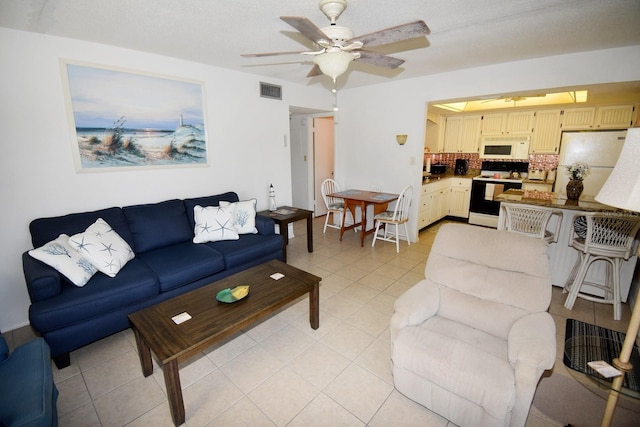 320 Base Ave E Unit 215, Venice, FL 34285 - living area with ceiling fan and light tile patterned floors