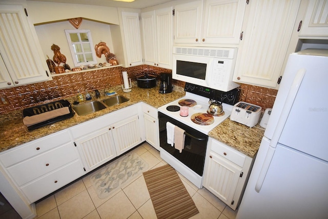 320 Base Ave E Unit 215, Venice, FL 34285 - kitchen featuring white appliances, tasteful backsplash, light tile patterned flooring, and stone countertops