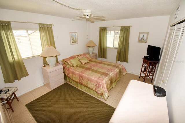 320 Base Ave E Unit 215, Venice, FL 34285 - bedroom with tile patterned flooring, a closet, and a ceiling fan
