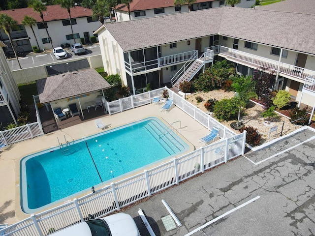 320 Base Ave E Unit 215, Venice, FL 34285 - community pool with a fenced backyard, a patio area, and stairway