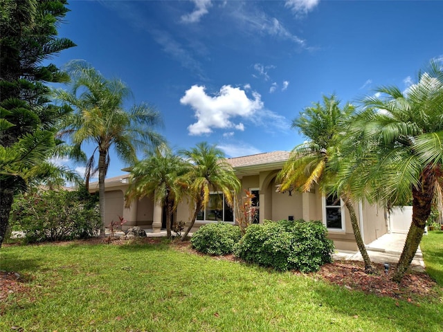 23102 Madelyn Ave, Port Charlotte, FL 33954 - view of front of house featuring stucco siding and a front lawn