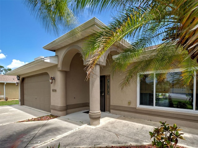 23102 Madelyn Ave, Port Charlotte, FL 33954 - view of front of property with stucco siding, a garage, and concrete driveway